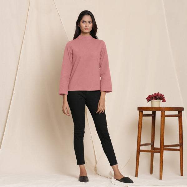 Front View of a Model wearing Warm English Rose Turtleneck Straight Top