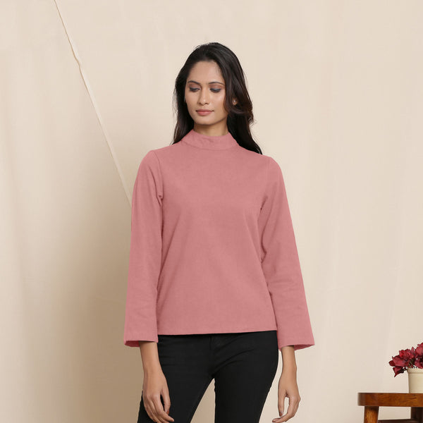 Front View of a Model wearing Warm English Rose Turtleneck Straight Top