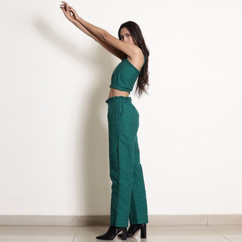 Left View of a Model wearing Warm Green Frilled Bustier Top and Pant Set