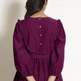 Back Detail of a Model wearing Warm Mulberry 100% Cotton Frilled Yoke Dress
