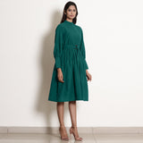 Right View of a Model wearing Warm Pine Green Fit and Flare Dress
