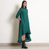 Right View of a Model wearing Warm Pine Green Frilled Neck High Low Dress