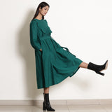 Right View of a Model wearing Pine Green Warm Cotton Frilled Midi Yoke Dress