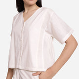 Left View of a Model wearing White Button-Down Paneled Cotton Top
