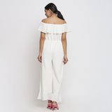 Back View of a Model wearing White Warm Cotton Corduroy Frilled Ankle Length Jumpsuit