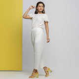 Left View of a Model wearing White Cotton Lace Hand Embroidered Jumpsuit