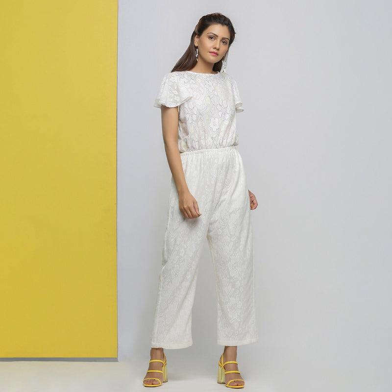 Right View of a Model wearing White Cotton Lace Hand Embroidered Jumpsuit