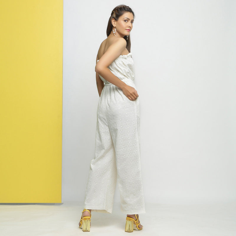 Back View of a Model wearing White Cotton Schiffli Floral Elasticated Tube Neck Jumpsuit