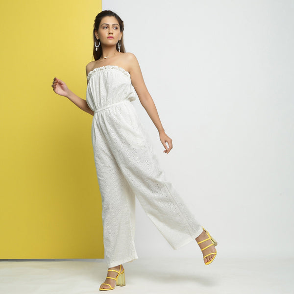 Left View of a Model wearing White Cotton Schiffli Floral Elasticated Tube Neck Jumpsuit