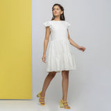 Front View of a Model wearing White Cotton Schiffli Short Tiered Dress
