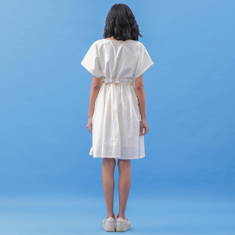 Back View of a Model wearing White Cotton V-Neck Frilled Bohemian Dress