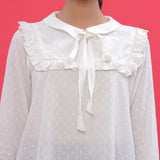 Front Detail of a Model wearing White Dobby Ruffled Peasant Blouse Top