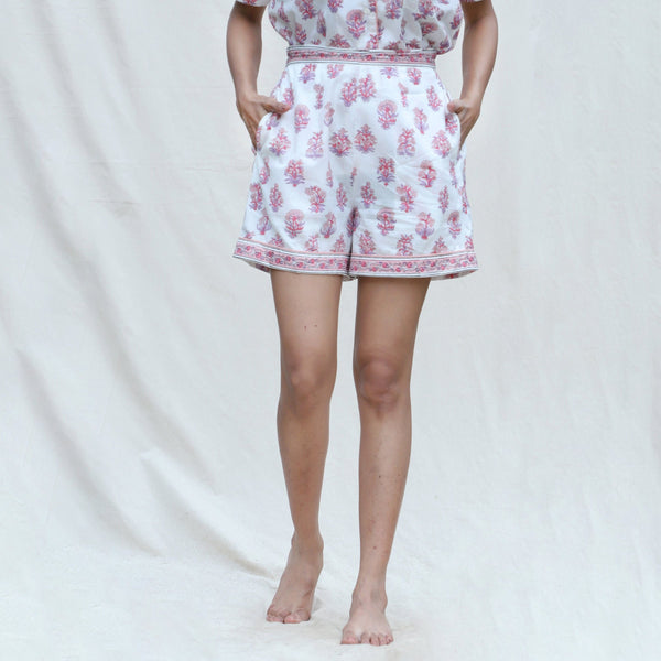 Front View of a Model wearing White and Fuchsia Block Printed Cotton High-Rise Elasticated Shorts