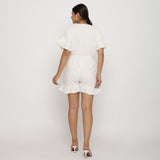 Back View of a Model wearing White Frilled Sleeve Cotton Playsuit