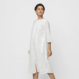 Left View of a Model wearing White Organic Cotton Hand Beaded Button-Down Midi Dress
