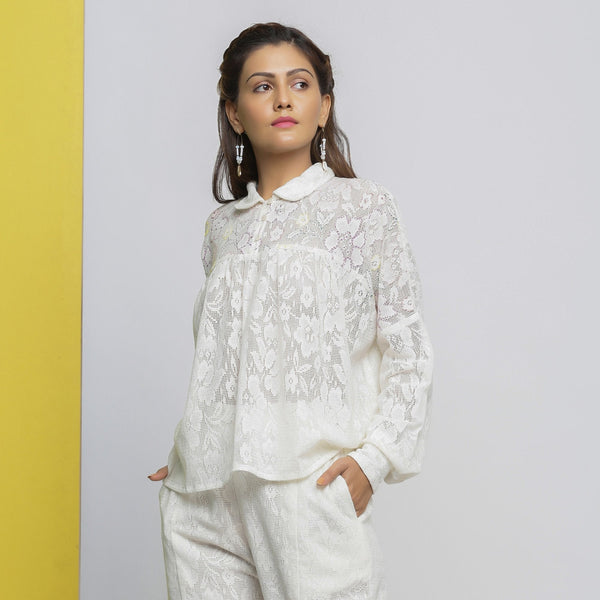 Left View of a Model wearing White Floral Hand-Embroidered Cotton Lace Yoked Shirt