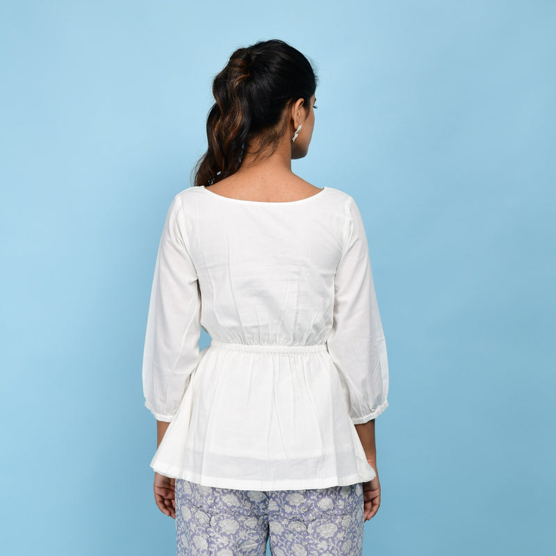 Back View of a Model wearing White Organic 100% Cotton Round Neck Peplum Top
