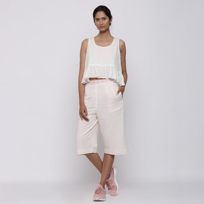 Front View of a Model wearing White Peplum Top and Powder Pink Culottes Set