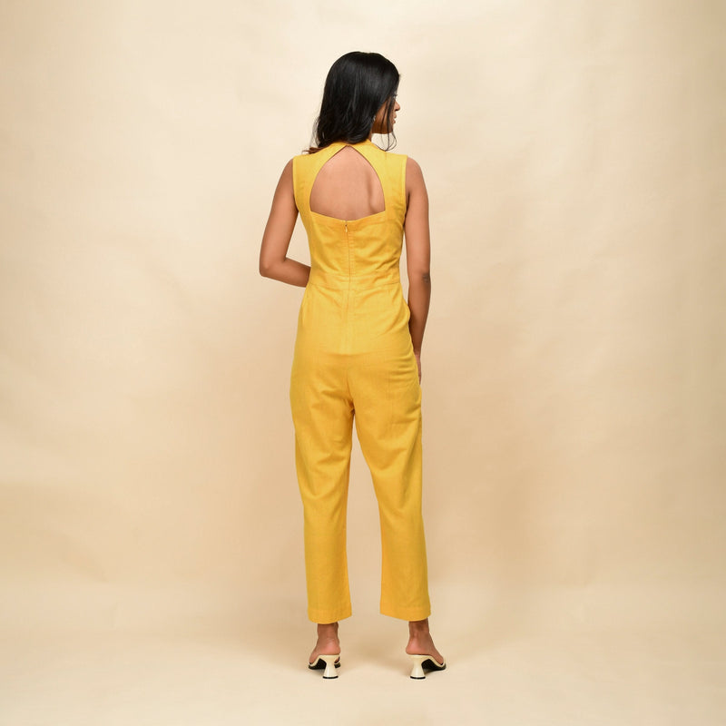 Back View of a Model wearing Yellow Cotton Khadi Sleeveless Jumpsuit
