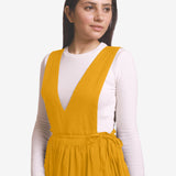 Front Detail of a Model wearing Yellow Deep Neck Pinafore Midi Wrap Dress