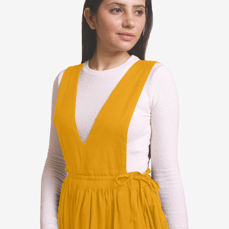 Front Detail of a Model wearing Yellow Deep Neck Pinafore Midi Wrap Dress