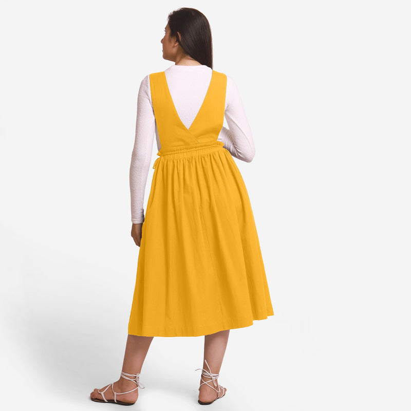 Back View of a Model wearing Yellow Deep Neck Pinafore Midi Wrap Dress