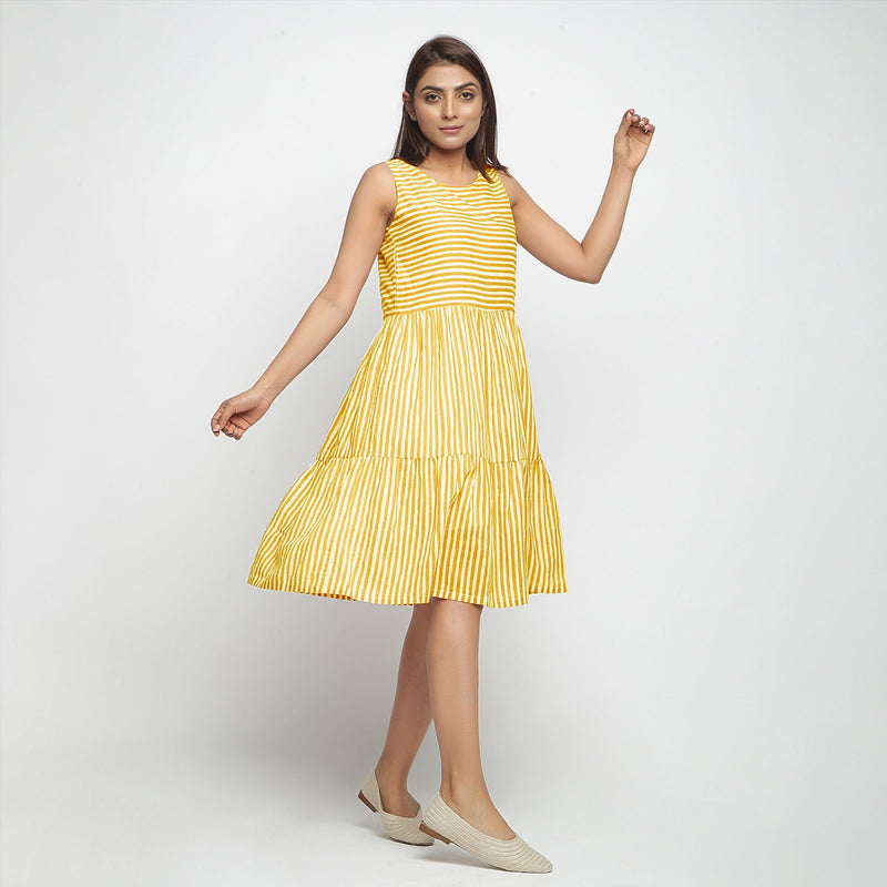 Right View of a Model wearing Yellow Hand Screen Printed Lined Tiered Dress