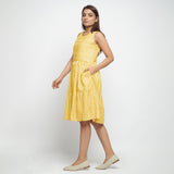 Left View of a Model wearing Yellow Hand Screen Printed Lined Tiered Dress