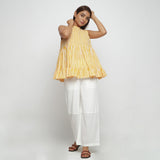 Front View of a Model wearing Yellow Tiered Hand Screen Printed Top