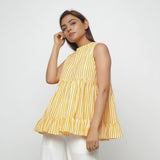 Left View of a Model wearing Yellow Tiered Hand Screen Printed Top
