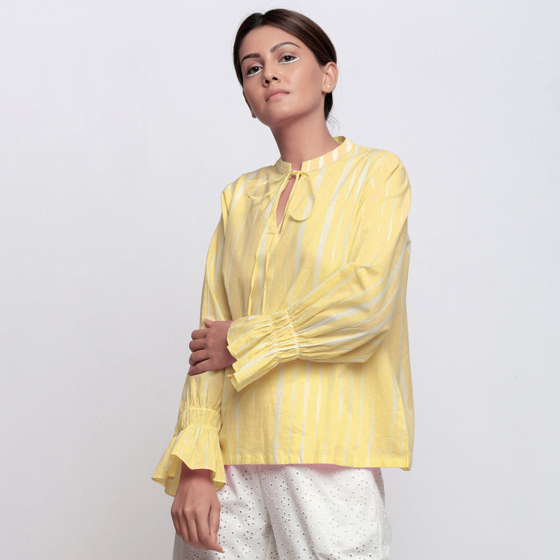 Left View of a Model wearing Yellow Hand Tie Dyed Shirred Blouson Top