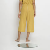 Back View of a Model wearing Yellow Vegetable Dyed Handspun Cotton Mid-Rise Culottes