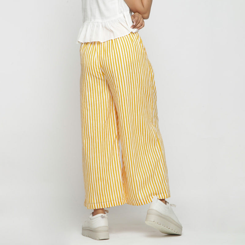 Back View of a Model wearing Yellow Striped Wide Legged Cotton Pant