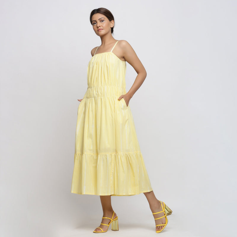 Left View of a Model wearing Yellow Hand Tie-Dye Cotton Midi Tiered Dress