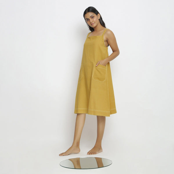 Left View of a Model wearing Yellow Vegetable Dyed Handspun Slip Dress