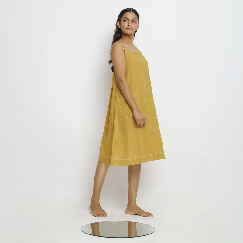 Right View of a Model wearing Yellow Vegetable Dyed Handspun Slip Dress