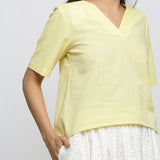 Front Detail of a Model wearing Yellow Yarn Dyed Cotton V-Neck High-Low Top